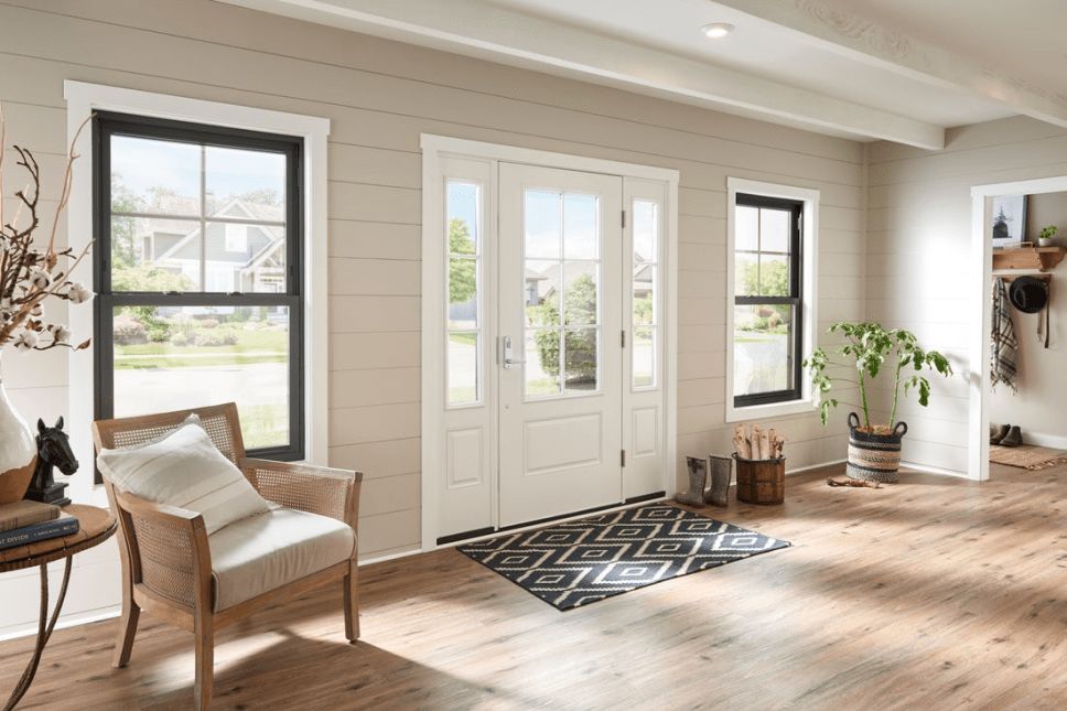 Interior of a home entrance with a white entry door and sidelites.