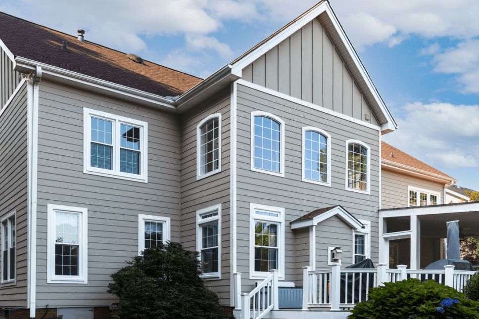 Two-story home with a variety of vinyl window shapes and configurations.